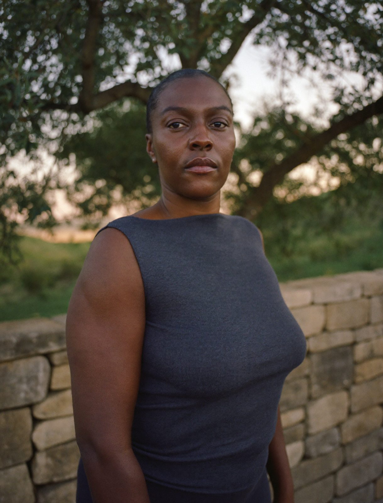 Ife Coleman, movement teacher, on a stone terrace at dusk