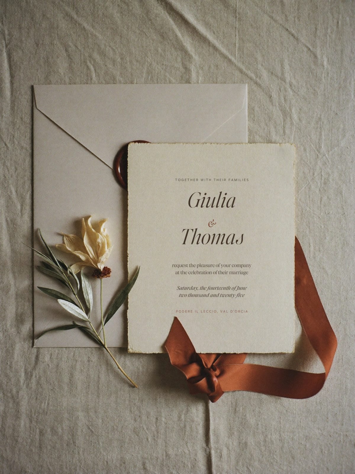 Letterpress wedding invitation for Giulia and Thomas with a terracotta wax seal, matching silk ribbon, olive and a dried oleander bloom