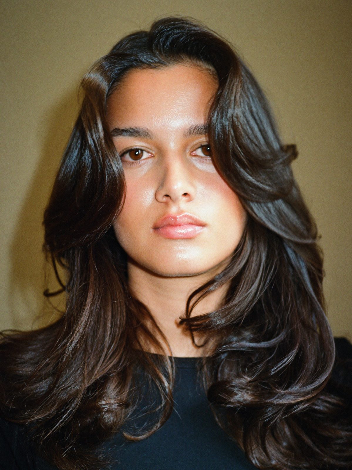 After: the same client with a long layered cut, soft root smudge and a high-shine gloss